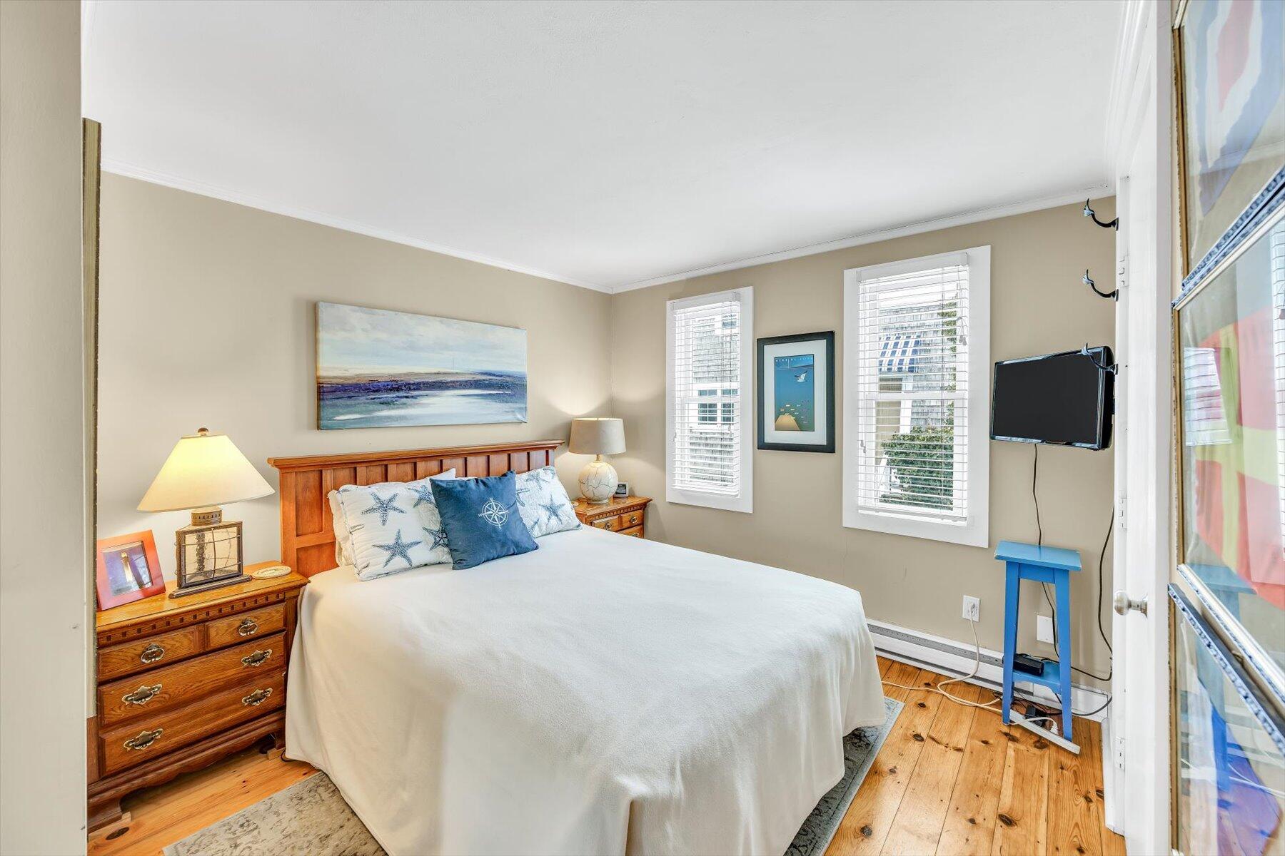15 Cottage Street, Unit 2 Provincetown, MA 02657 - Photo 11 of 27 a bedroom with a bed and a large window