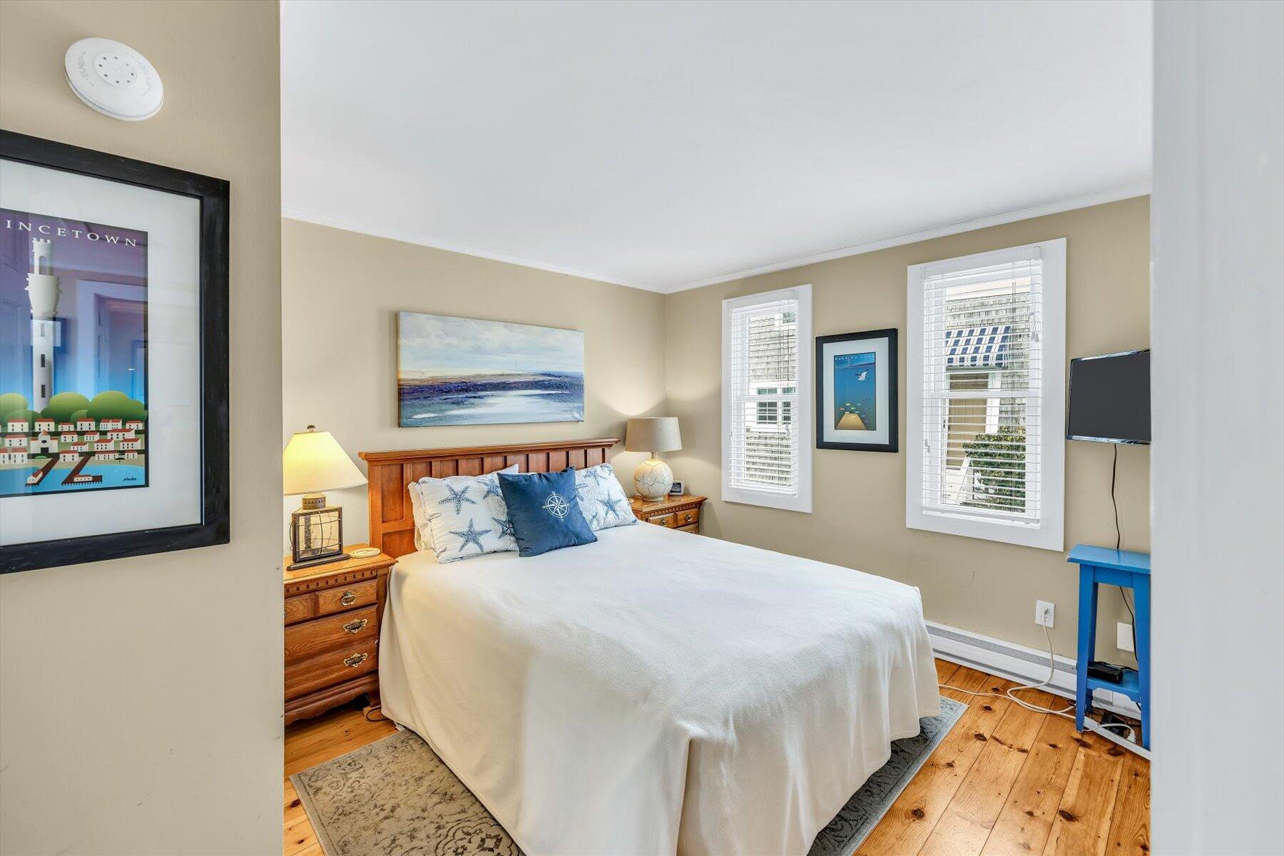 15 Cottage Street, Unit 2 Provincetown, MA 02657 - Photo 14 of 27 a bedroom with a bed and a window
