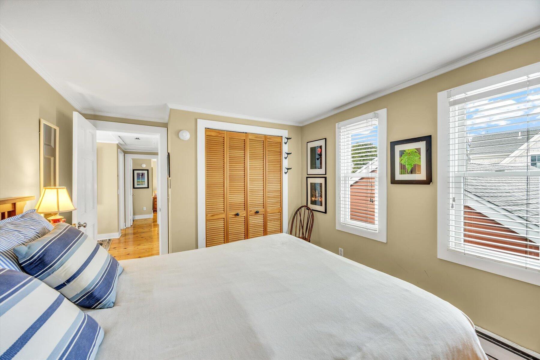 15 Cottage Street, Unit 2 Provincetown, MA 02657 - Photo 16 of 27 a bedroom with a large bed and wooden floor