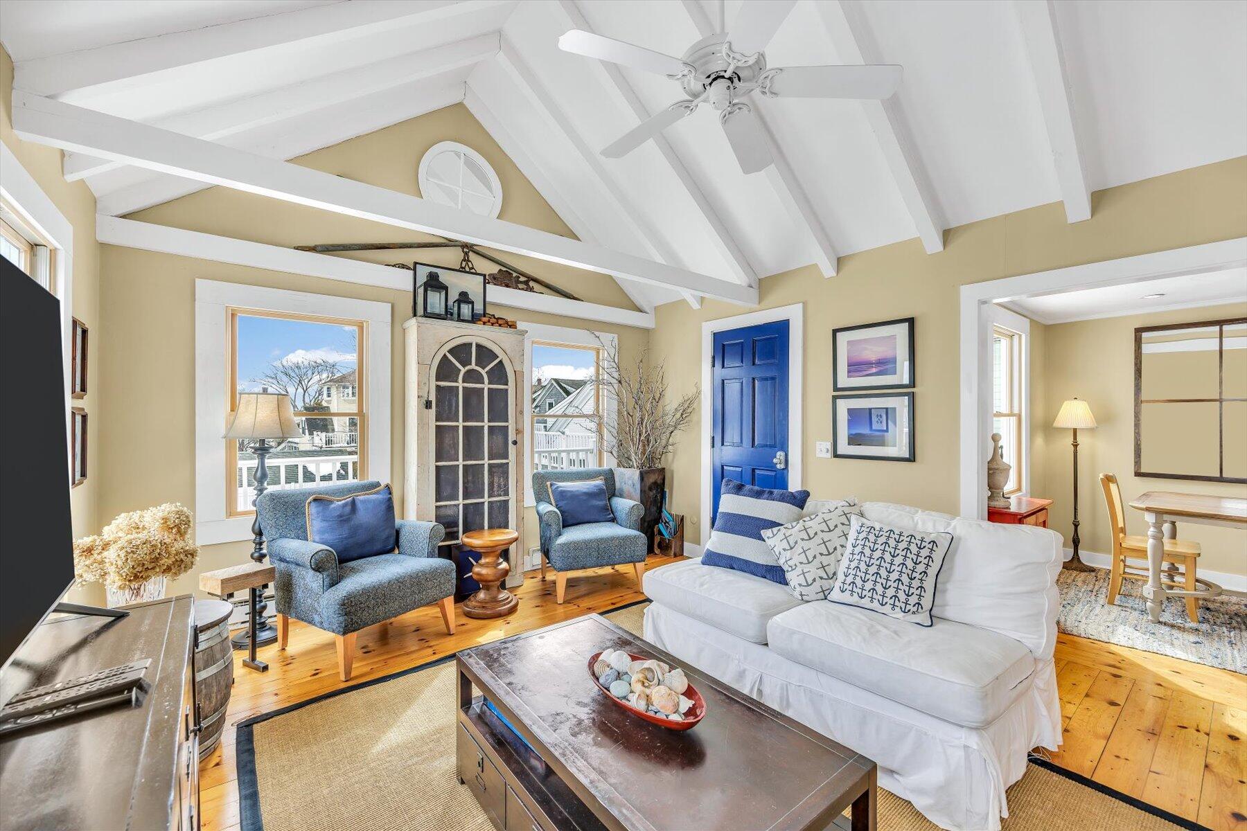 15 Cottage Street, Unit 2 Provincetown, MA 02657 - Photo 2 of 27 a living room with furniture a rug and a chandelier