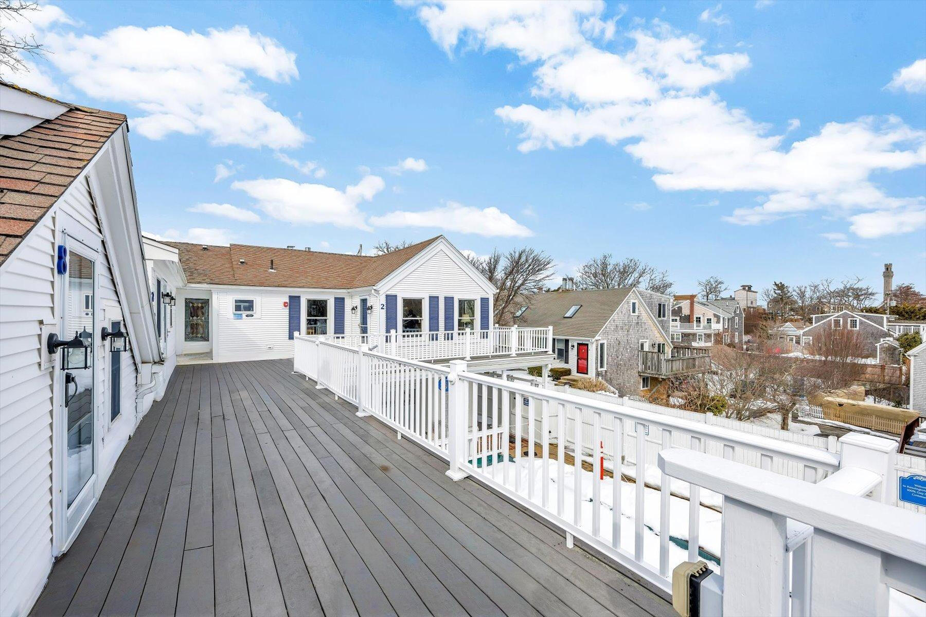 15 Cottage Street, Unit 2 Provincetown, MA 02657 - Photo 24 of 27 a view of a house with wooden deck