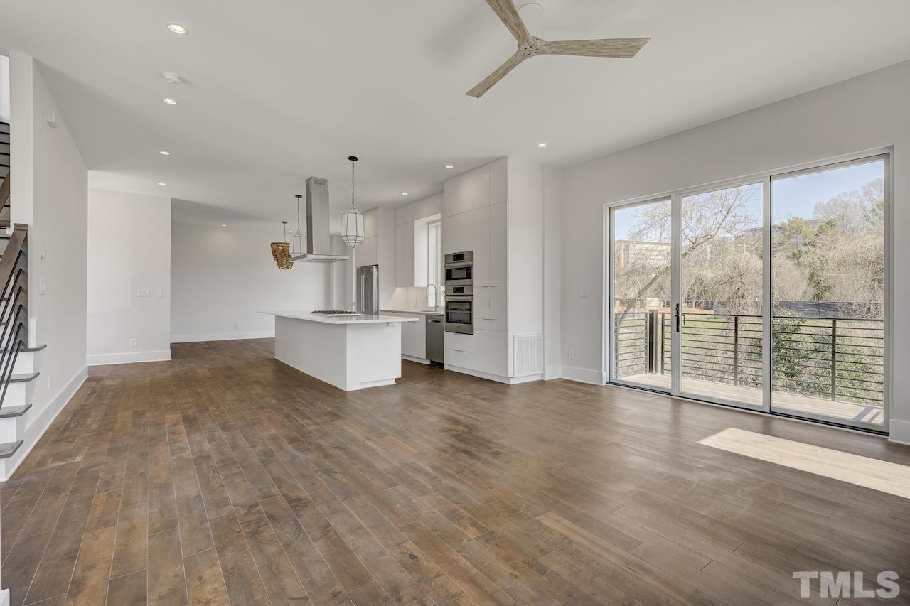 1026 Manor Way Durham, NC 27701 - Photo 6 of 24 a view of a big room with wooden floor and windows