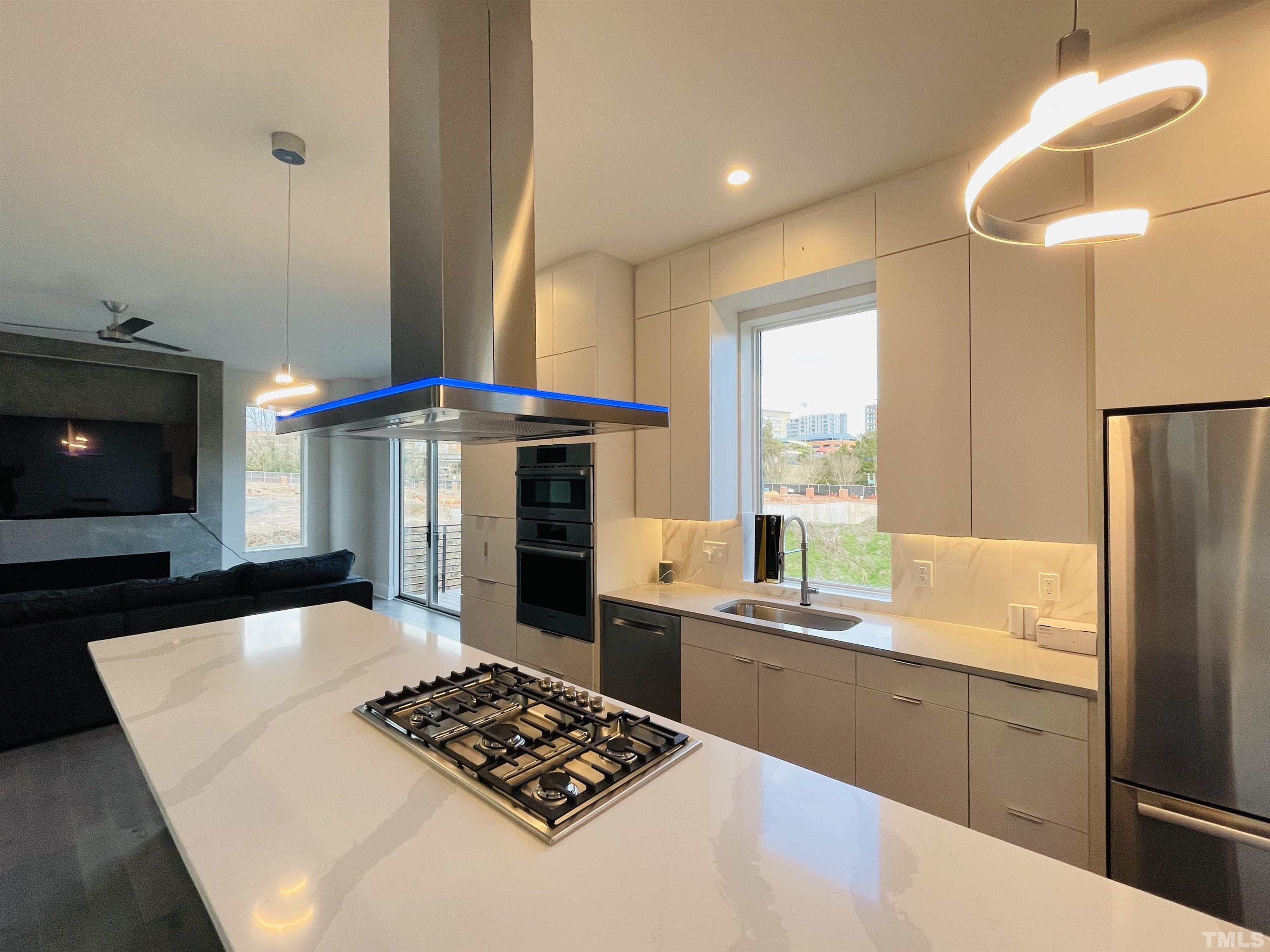 1026 Manor Way Durham, NC 27701 - Photo 7 of 24 a kitchen with stainless steel appliances kitchen island granite countertop a sink stove and refrigerator
