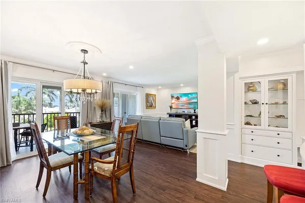 a dining room with furniture and wooden floor