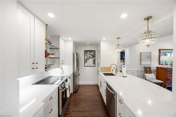 a large white kitchen with a large window
