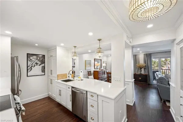 a open kitchen with stainless steel appliances kitchen island granite countertop a sink and cabinets