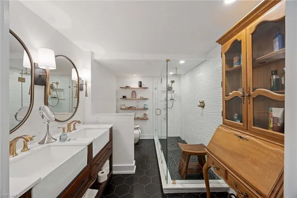 a bathroom with a sink a mirror a vanity and a bathtub
