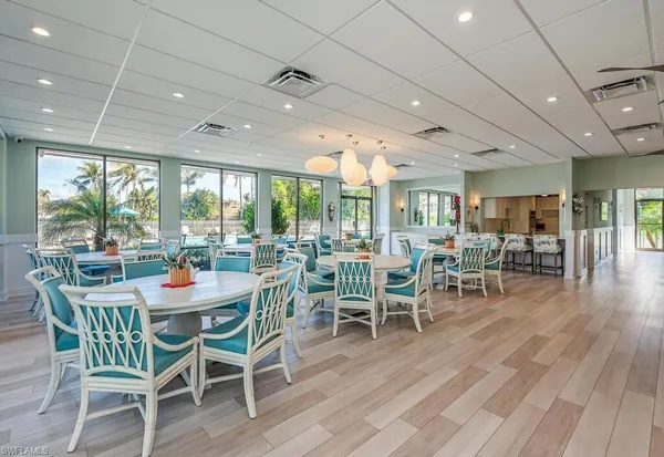 a dining room with furniture window and wooden floor