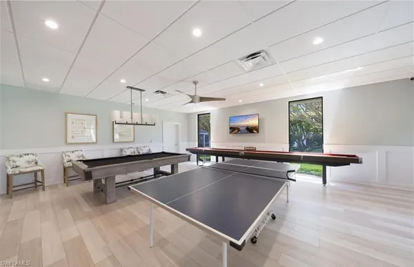 a indoor pool table with wooden floor