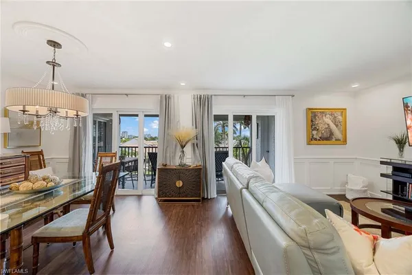 a living room with furniture a desk and chair with wooden floor