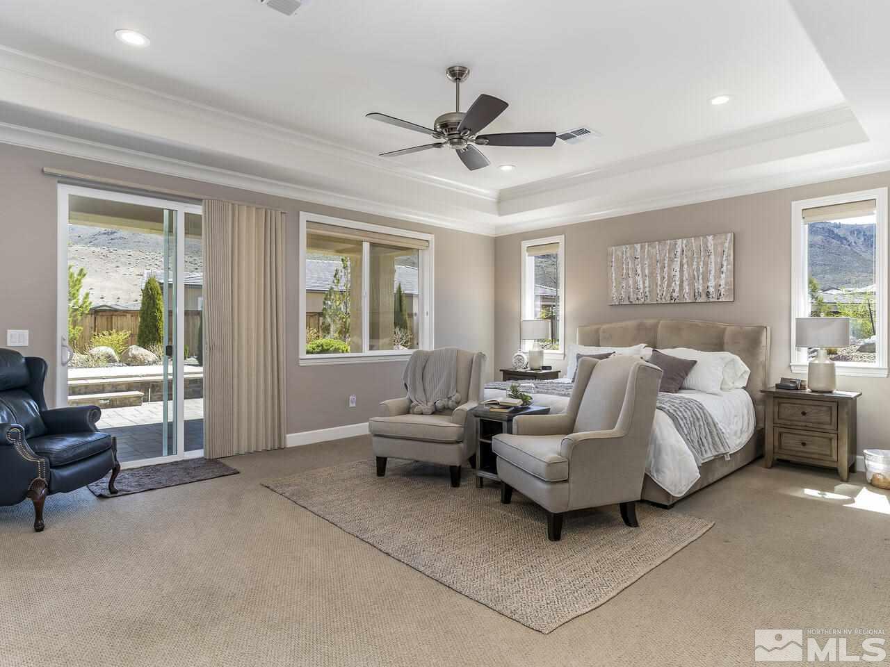 2913 Miramis Court Reno, NV 89521 - Photo 18 of 40 a spacious bedroom with a bed and glass window