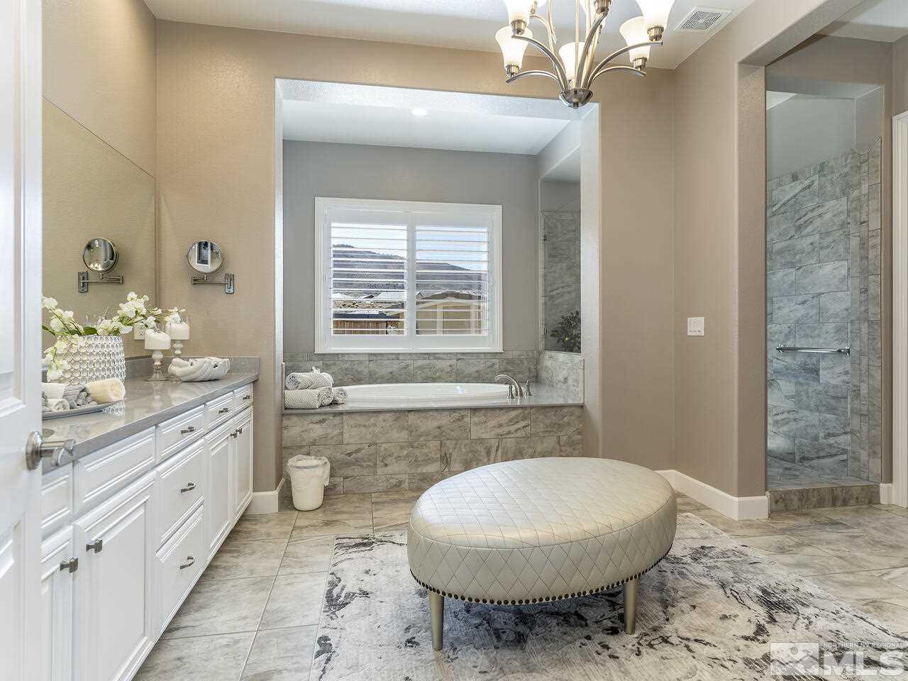2913 Miramis Court Reno, NV 89521 - Photo 19 of 40 a bathroom with a granite countertop sink toilet a mirror a vanity and shower