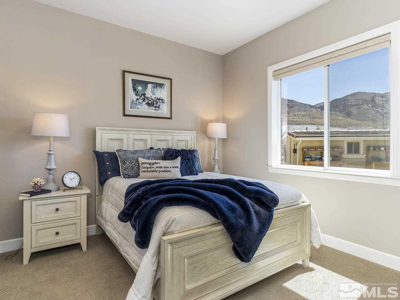 2913 Miramis Court Reno, NV 89521 - Photo 25 of 40 a bed sitting in a bedroom next to a window