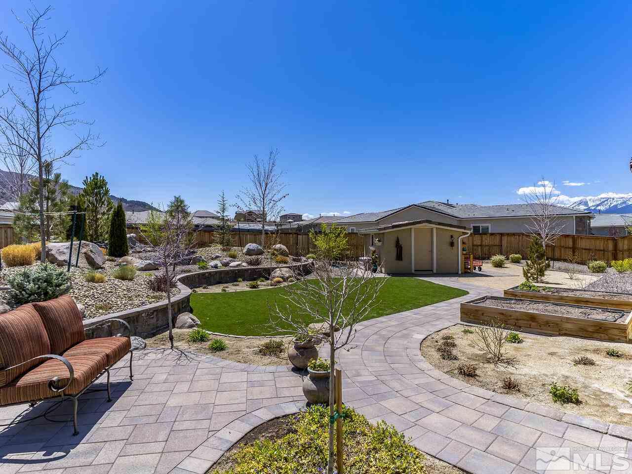 2913 Miramis Court Reno, NV 89521 - Photo 36 of 40 a view of a patio with a table and chairs under an umbrella