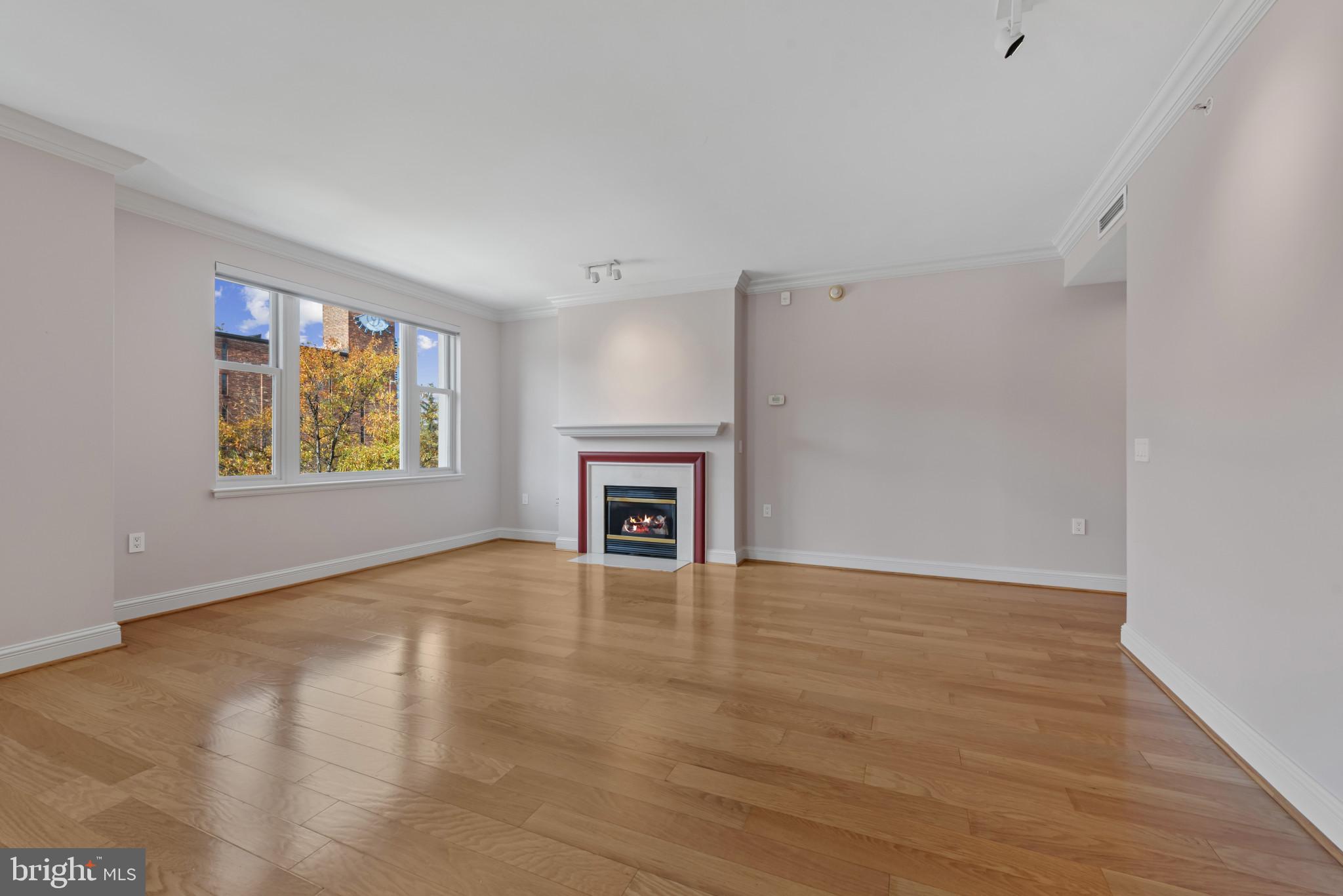 801 Key Highway, Unit 364 Baltimore, MD 21230 - Photo 12 of 54 a view of an empty room with a window and a fireplace