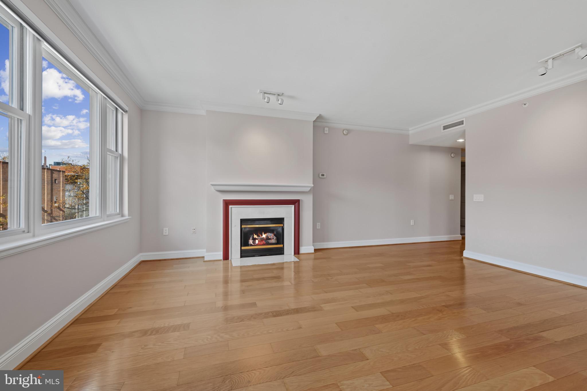 801 Key Highway, Unit 364 Baltimore, MD 21230 - Photo 13 of 54 a view of an empty room with a window and fireplace