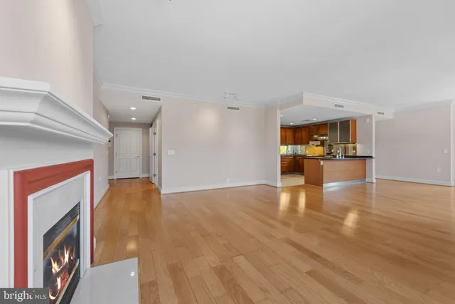 a view of a living room and a kitchen with a sink