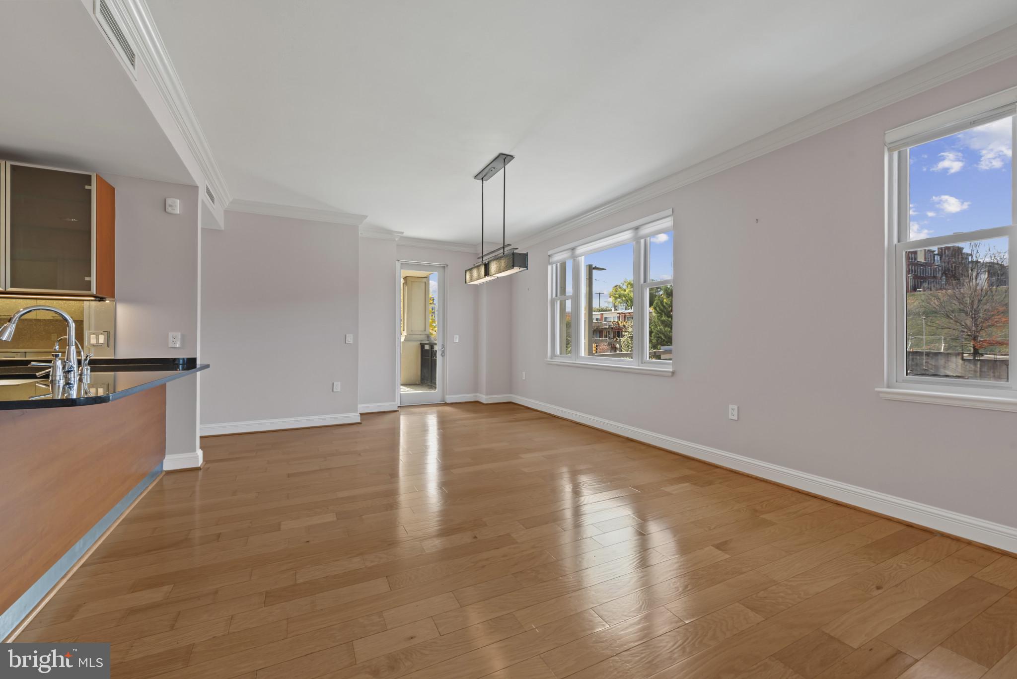 801 Key Highway, Unit 364 Baltimore, MD 21230 - Photo 18 of 54 a view of an empty room with window and wooden floor