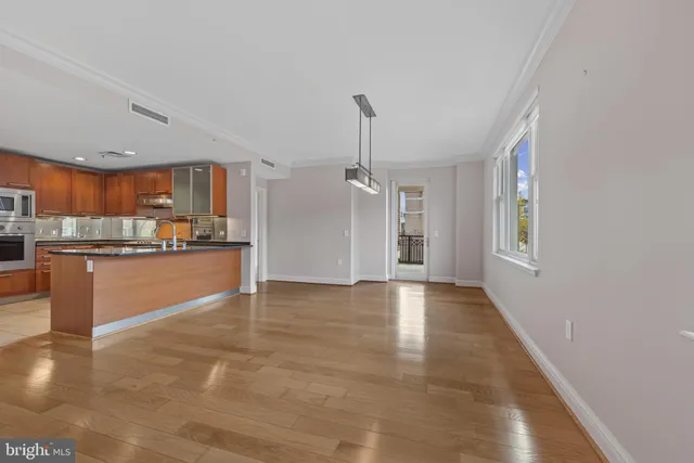a view of a livingroom with a furniture wooden floor and a window
