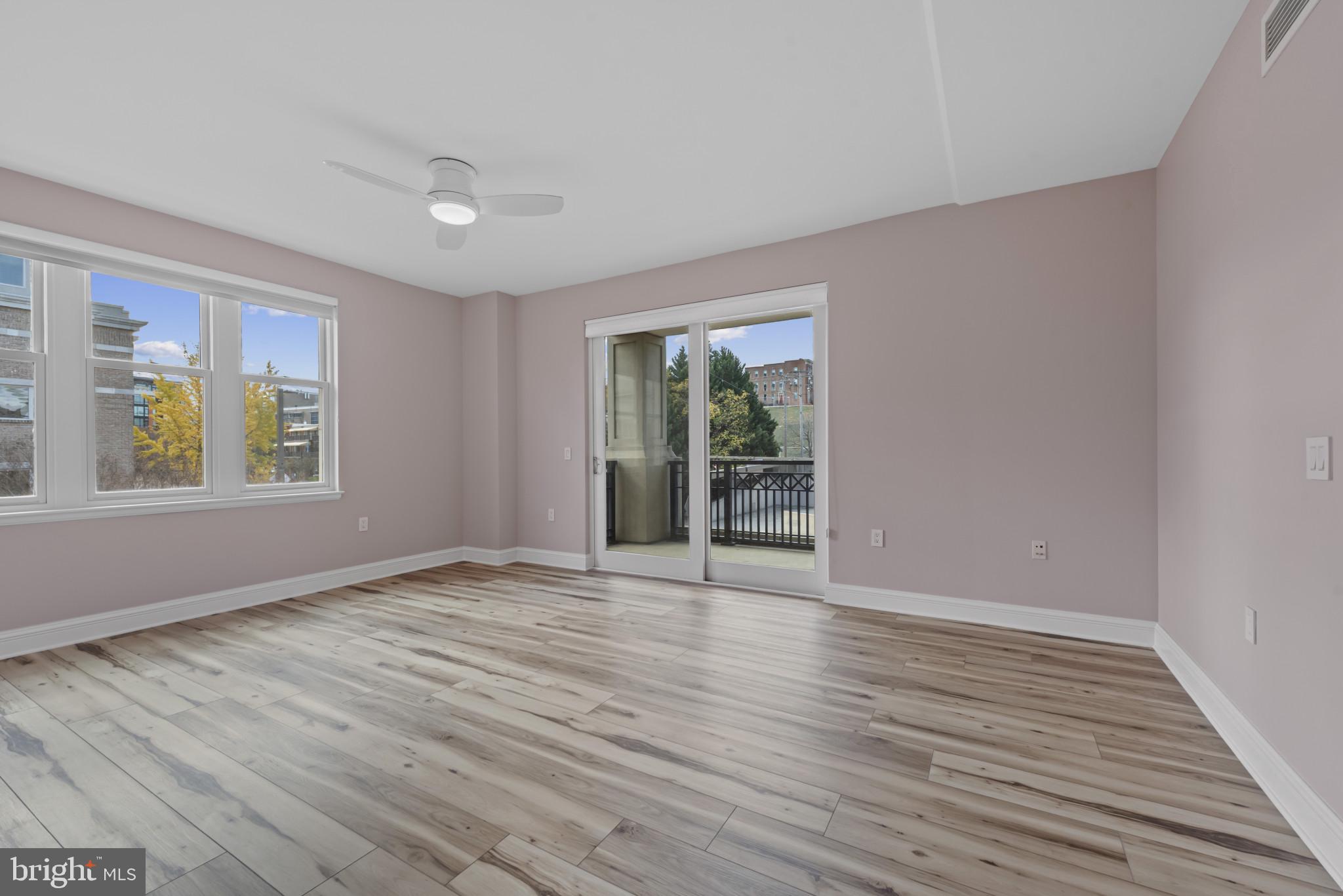801 Key Highway, Unit 364 Baltimore, MD 21230 - Photo 27 of 54 a view of an empty room with wooden floor and a window