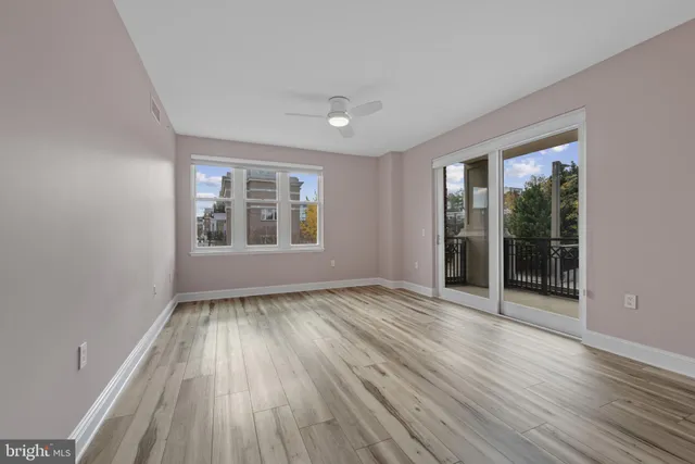 wooden floor in an empty room with a window