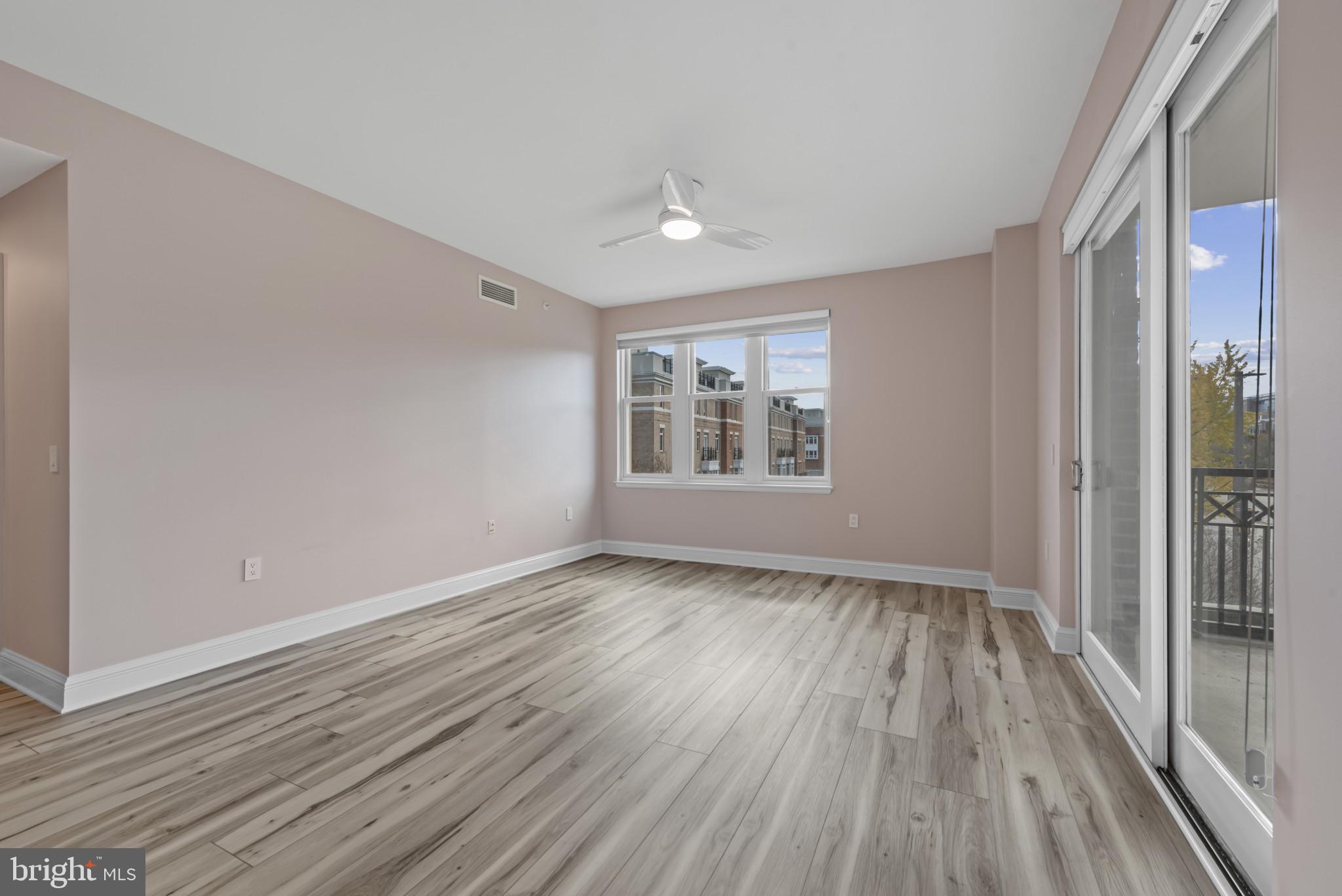 801 Key Highway, Unit 364 Baltimore, MD 21230 - Photo 31 of 54 a view of an empty room with wooden floor and a window