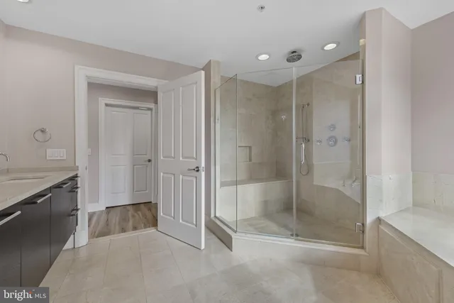 a bathroom with a sink a large mirror and a bathtub