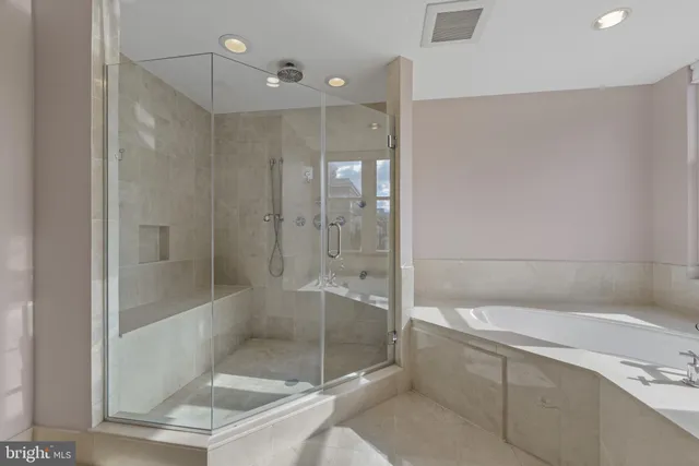 a bathroom with a tub sink and mirror