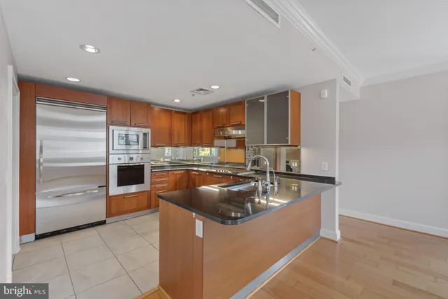 a kitchen with granite countertop stainless steel appliances and sink