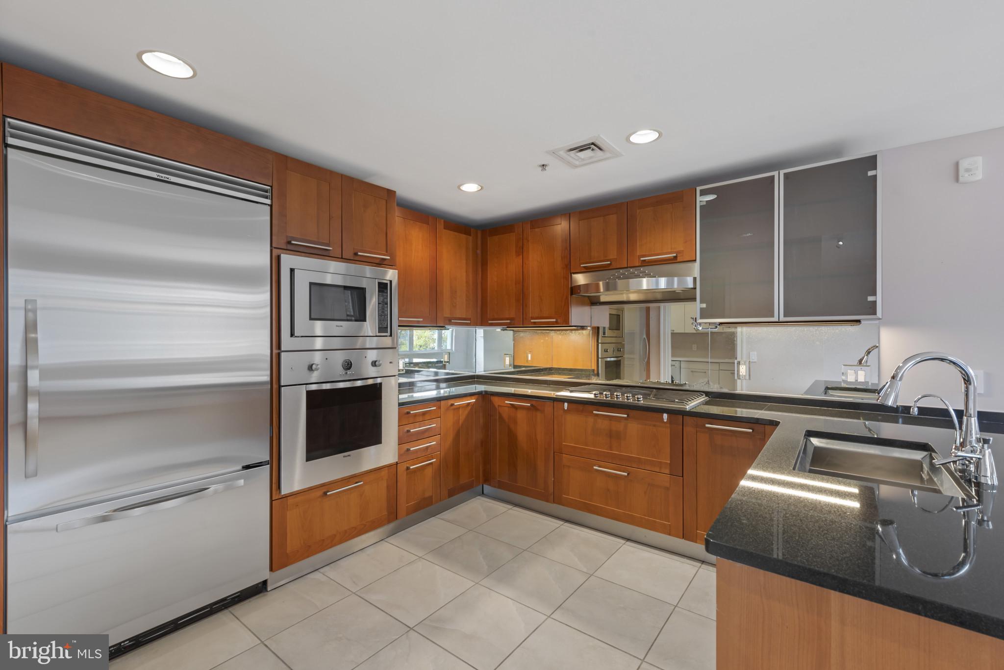 801 Key Highway, Unit 364 Baltimore, MD 21230 - Photo 6 of 54 a kitchen with granite countertop stainless steel appliances and sink