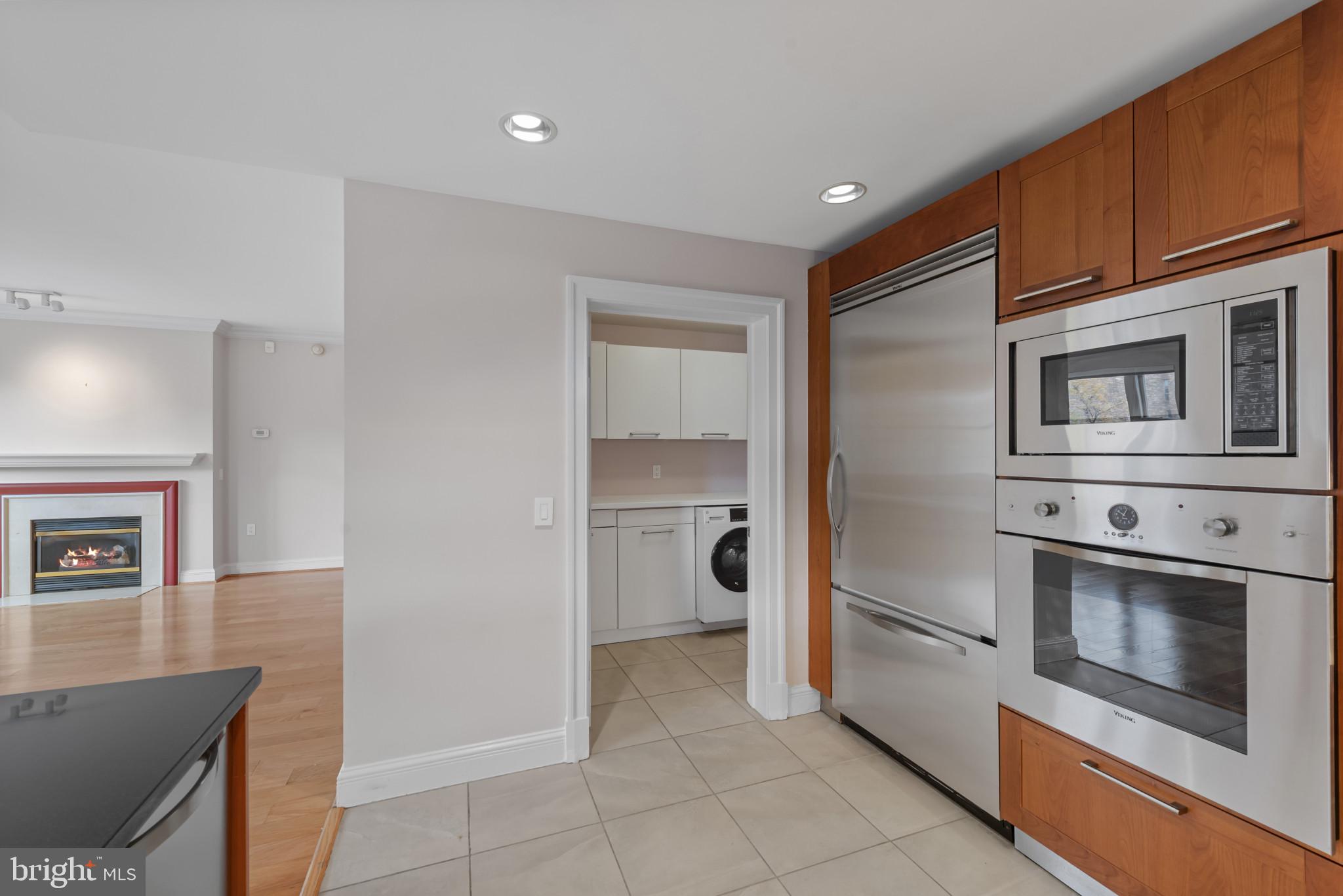 801 Key Highway, Unit 364 Baltimore, MD 21230 - Photo 9 of 54 a kitchen with stainless steel appliances granite countertop a refrigerator and a stove top oven