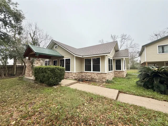 a front view of a house with a garden and yard
