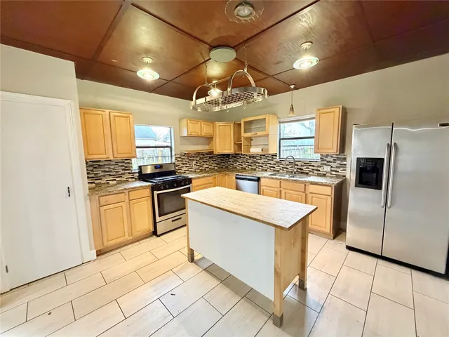 a kitchen with cabinets and stainless steel appliances