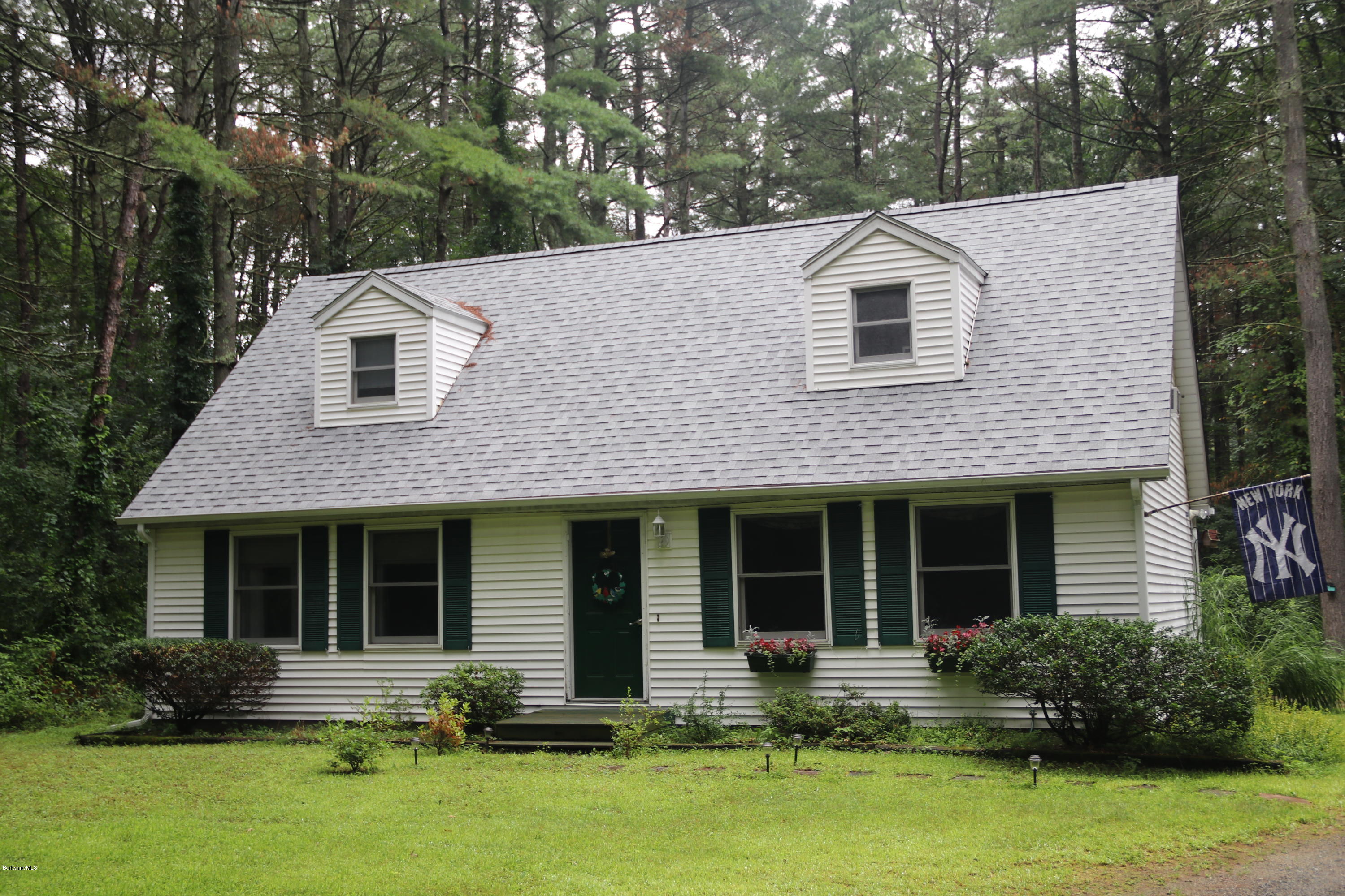 a front view of house with yard and outdoor seating