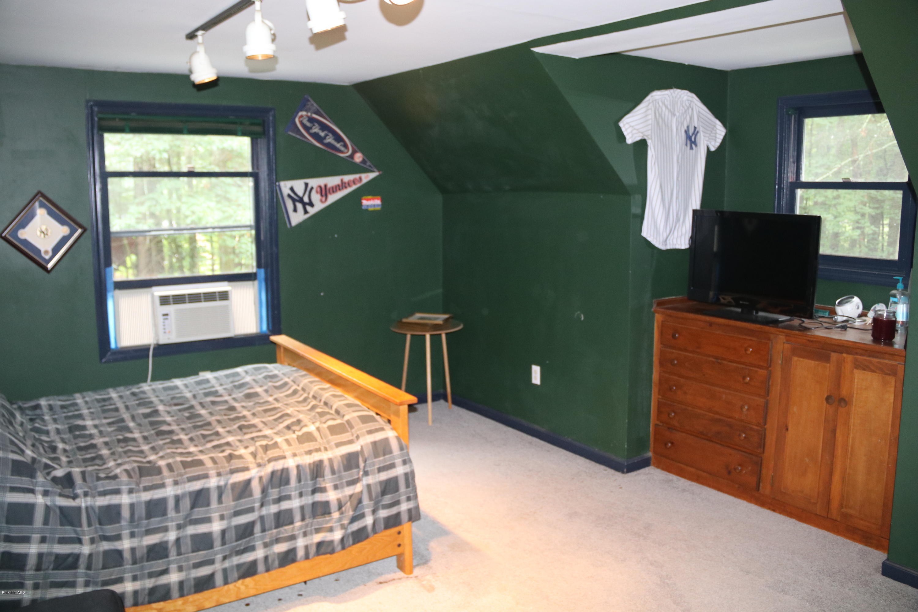 503 Polikoff Road Sheffield, MA 01222 - Photo 22 of 25 a bedroom with a bed and a mirror