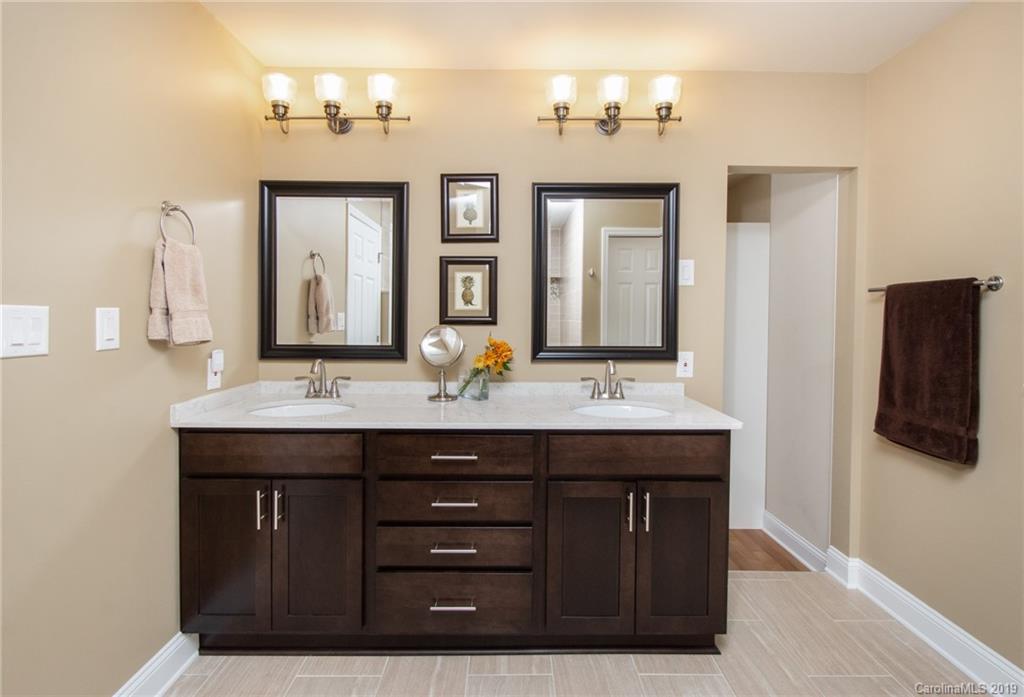 314 Steel Hill Road Lancaster, SC 29720 - Photo 16 of 47 a bathroom with a granite countertop sink and a mirror