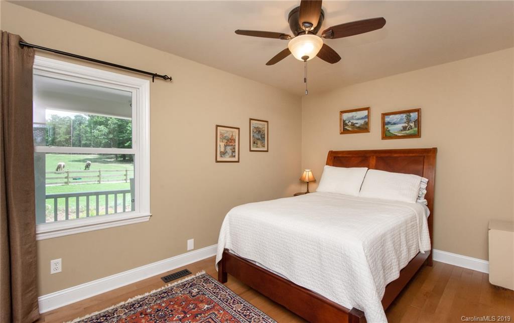 314 Steel Hill Road Lancaster, SC 29720 - Photo 18 of 47 a bedroom with a bed chandelier and a window
