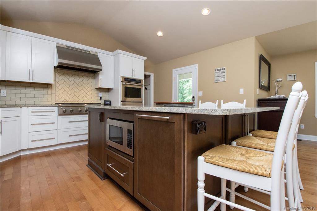 314 Steel Hill Road Lancaster, SC 29720 - Photo 23 of 47 a kitchen with stainless steel appliances kitchen island granite countertop a stove top oven a sink and dishwasher