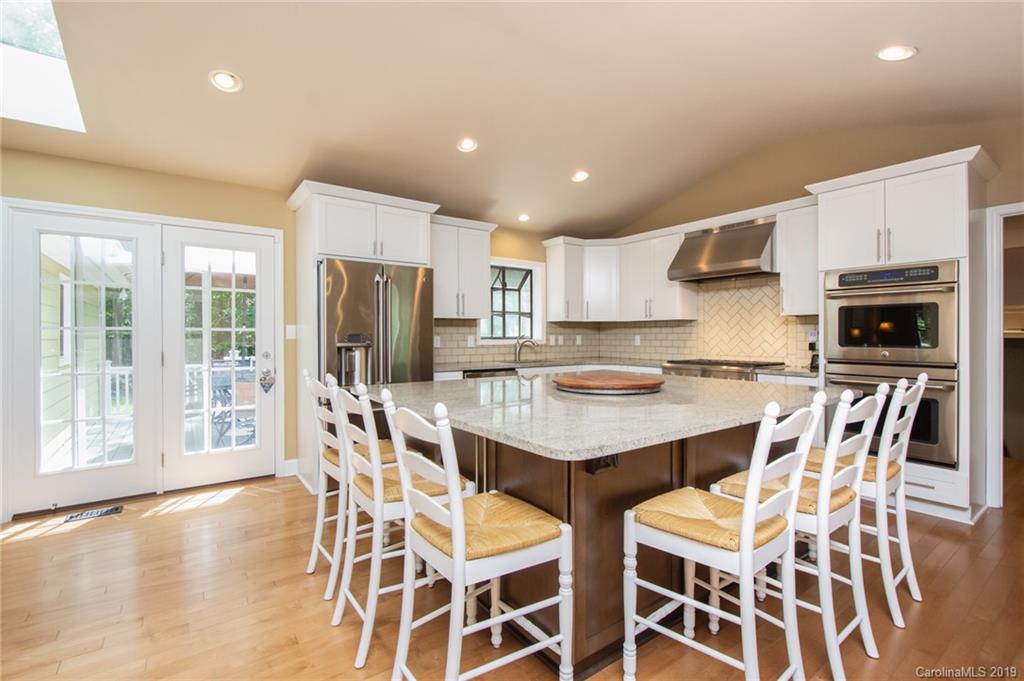 314 Steel Hill Road Lancaster, SC 29720 - Photo 25 of 47 a kitchen with stainless steel appliances a dining table chairs and refrigerator