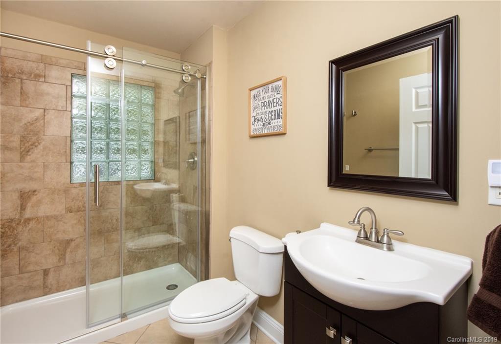 314 Steel Hill Road Lancaster, SC 29720 - Photo 28 of 47 a bathroom with a sink toilet a mirror and shower