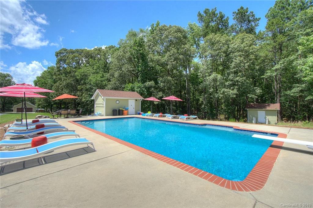 314 Steel Hill Road Lancaster, SC 29720 - Photo 33 of 47 a view of a swimming pool with a table and chairs under an umbrella
