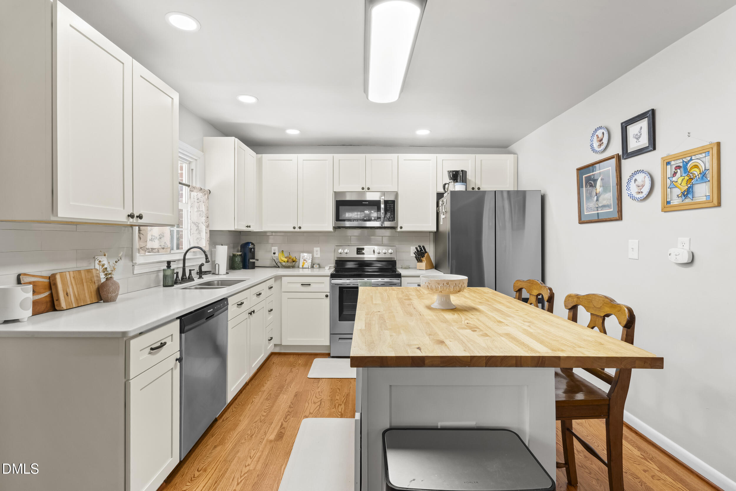 3032 Rosinburg Road Zebulon, NC 27597 - Photo 11 of 28 a large kitchen with kitchen island a dining table and chairs