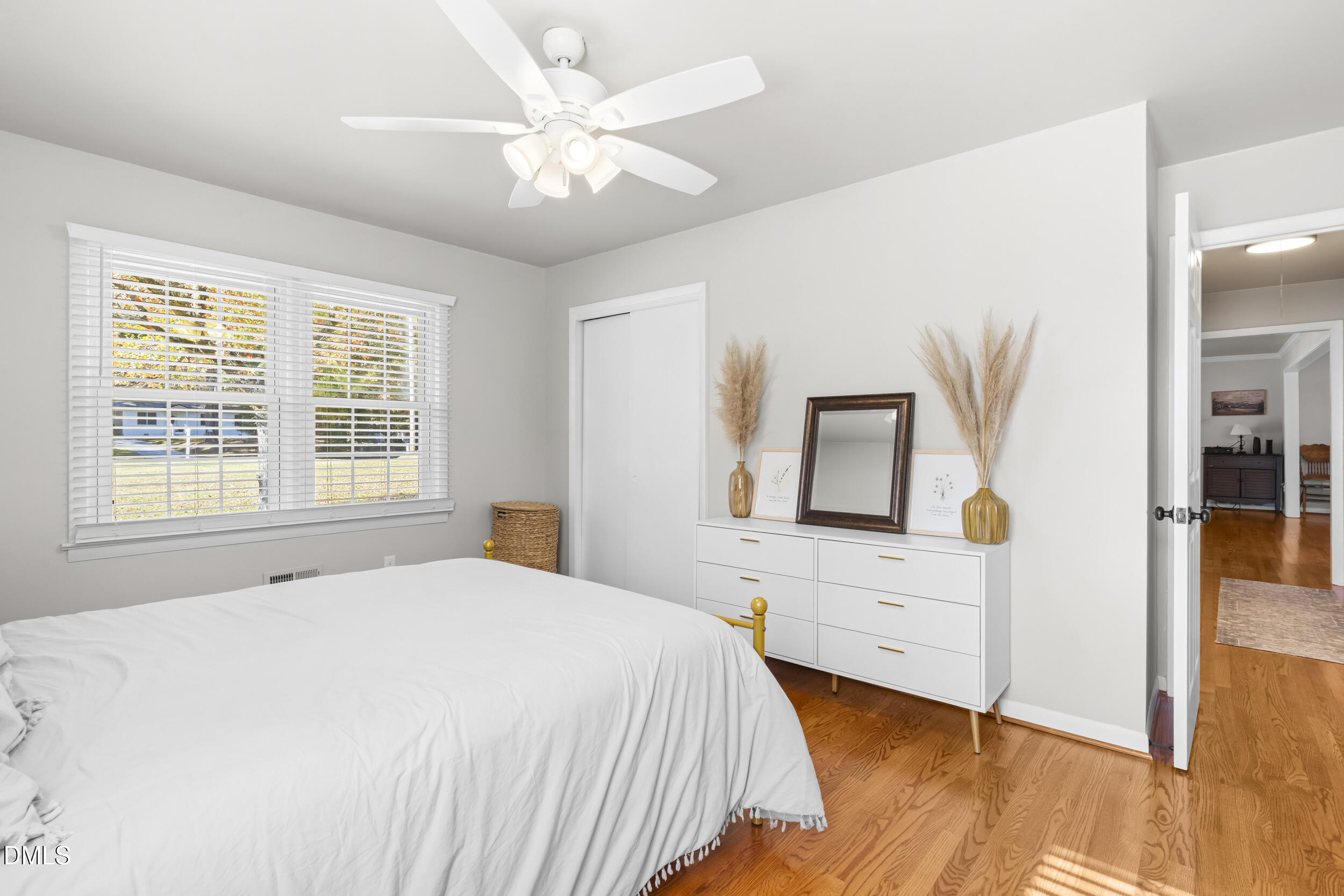 3032 Rosinburg Road Zebulon, NC 27597 - Photo 19 of 28 a bedroom with a large bed and a chandelier
