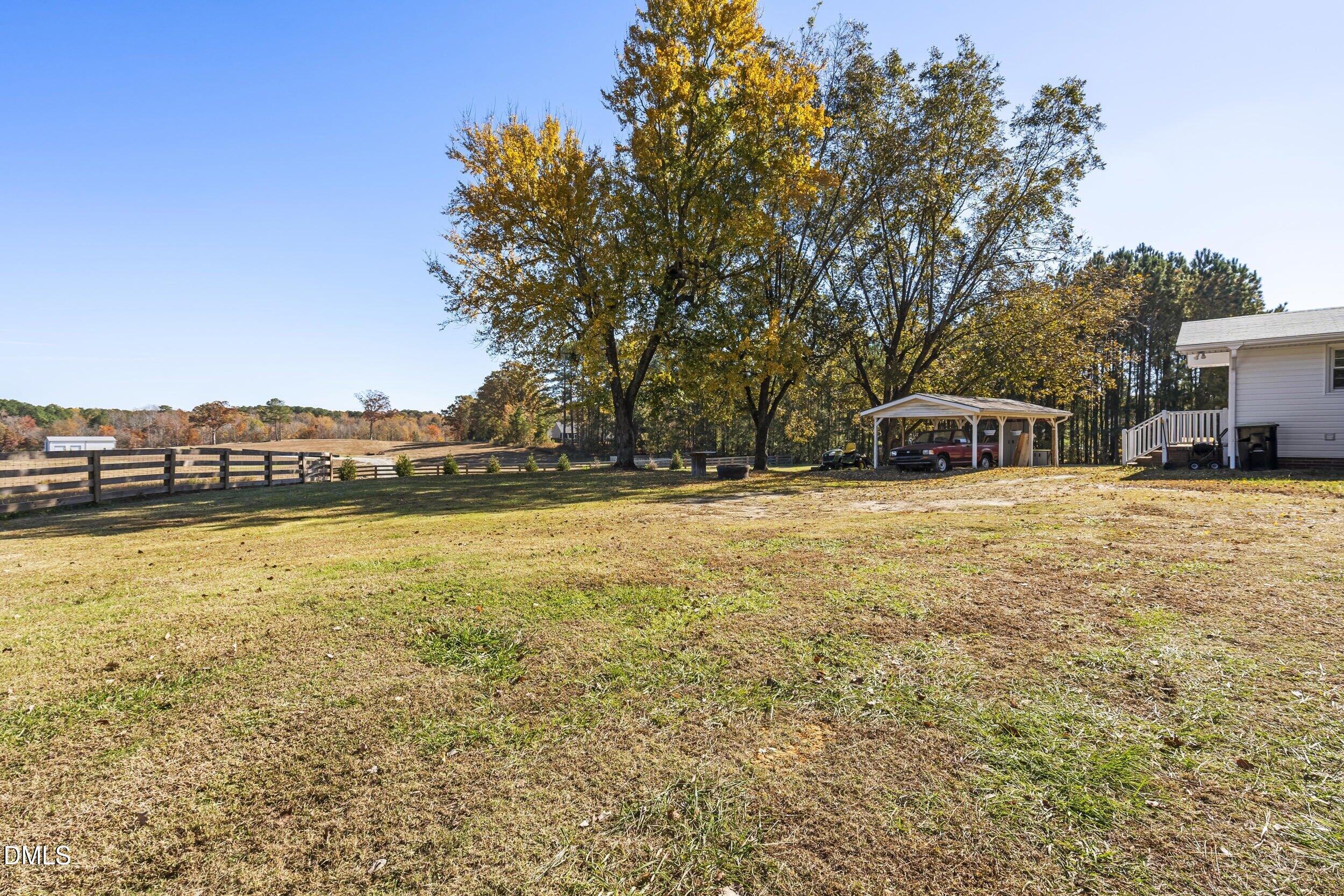 3032 Rosinburg Road Zebulon, NC 27597 - Photo 24 of 28 a view of a lake with houses and trees