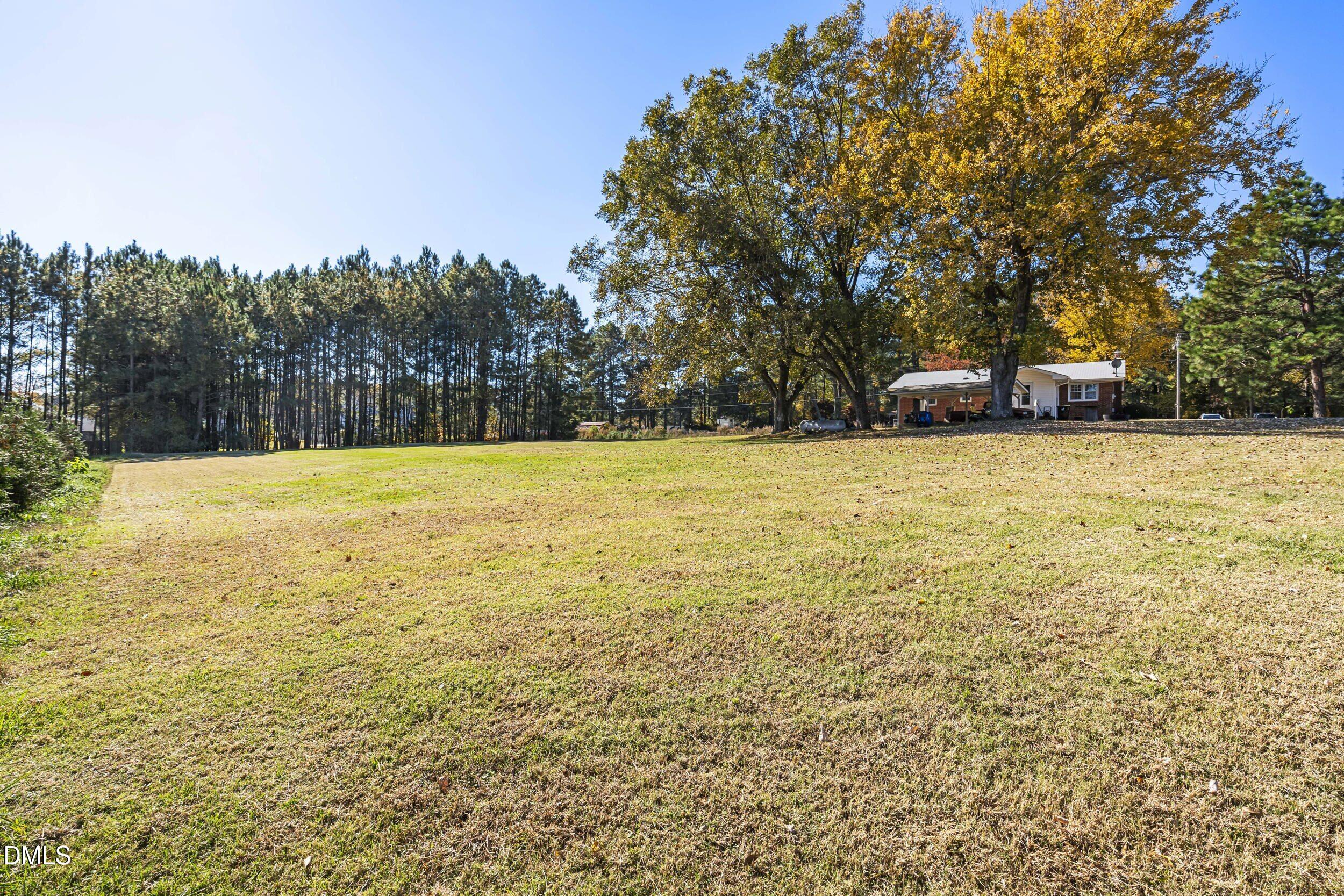 3032 Rosinburg Road Zebulon, NC 27597 - Photo 26 of 28 a view of swimming pool with trees in background