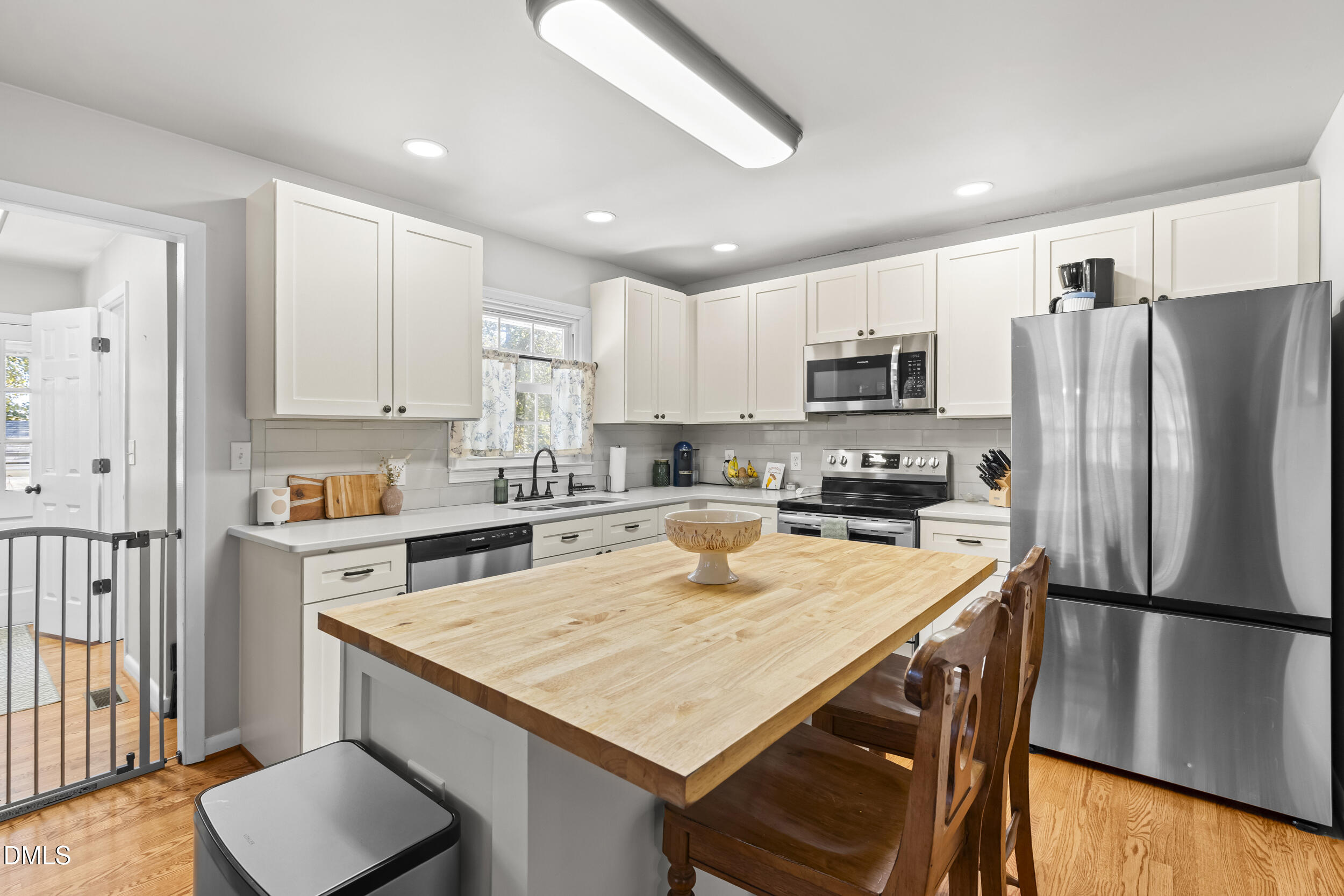 3032 Rosinburg Road Zebulon, NC 27597 - Photo 10 of 28 a kitchen with a refrigerator a stove a sink and a refrigerator