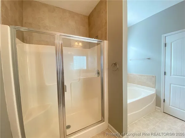 a bathroom with a glass shower door