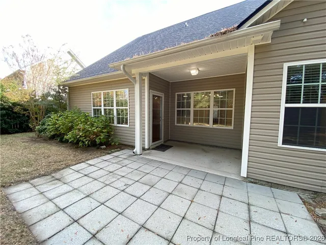 a front view of house with yard and trees