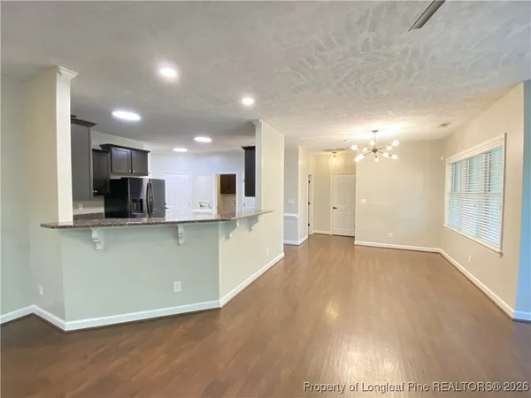 a view of a kitchen with a sink and a refrigerator