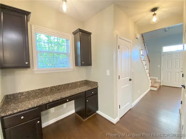 a view of a kitchen cabinets and wooden floor
